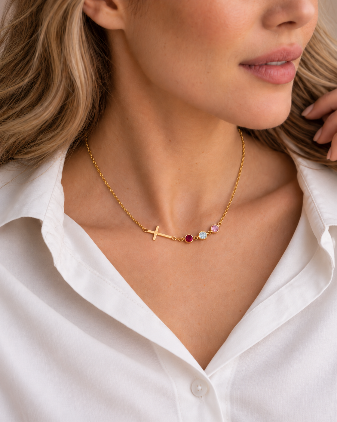 Inès Cross Birthstone Necklace in gold worn on model — raised view