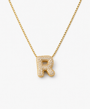 Inori Pavé Initial Necklace — gold on white/gray background