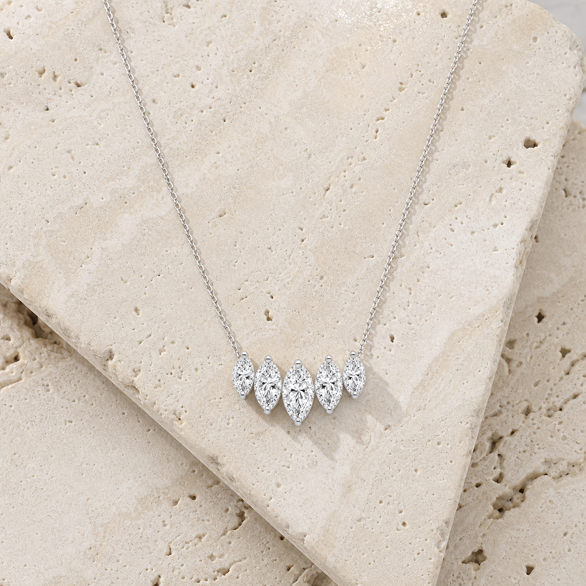Aurora Marquise Pendant Necklace in silver on stone background