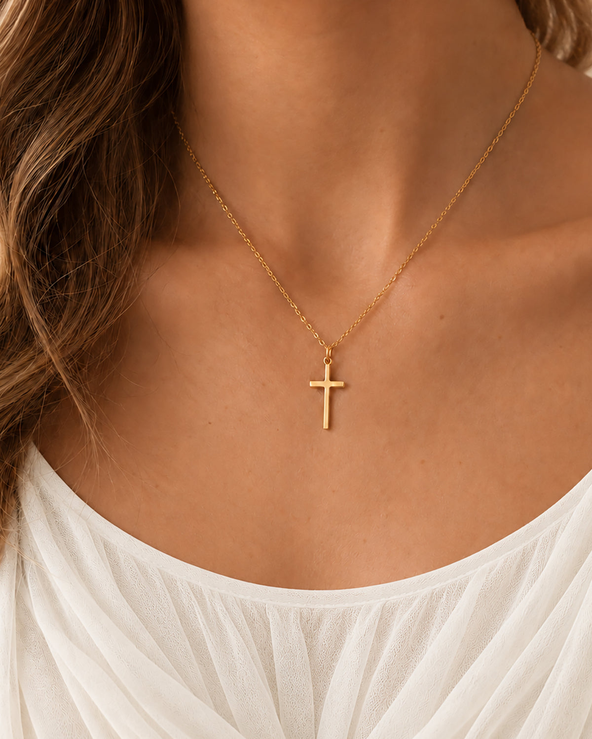 Céleste Cross Necklace in gold worn on model — front view