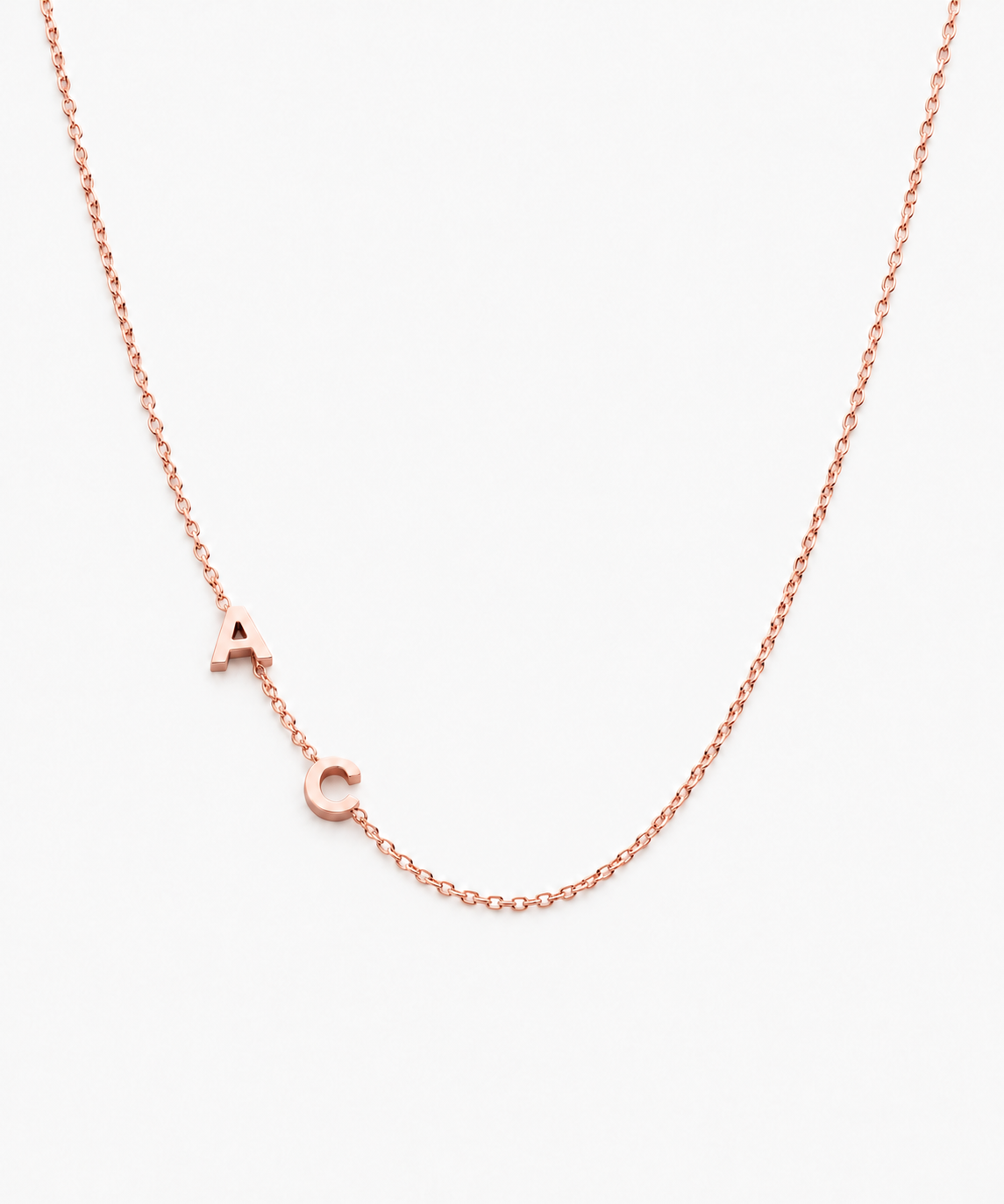 Sumi Sideways Initial Necklace — Rose Gold on white background