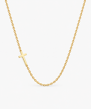 Estelle Sideways Cross Necklace — gold on white/gray background