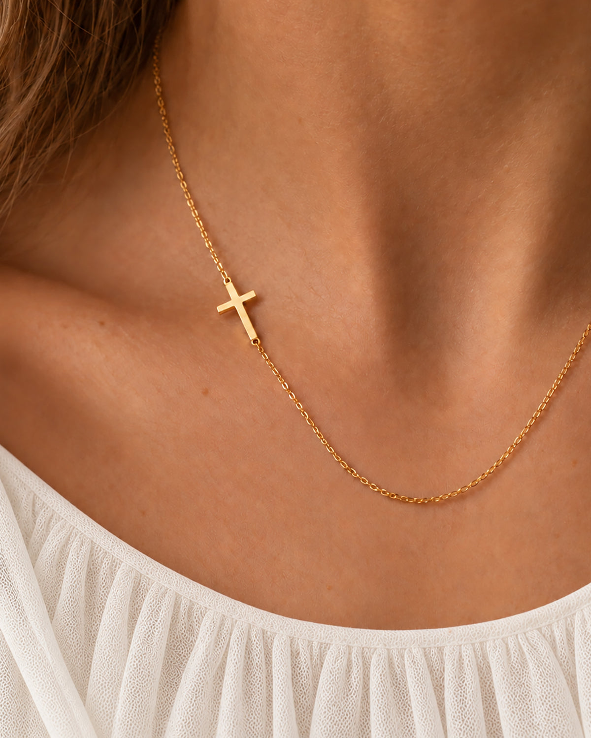 Estelle Sideways Cross Necklace in gold worn on model — view 1