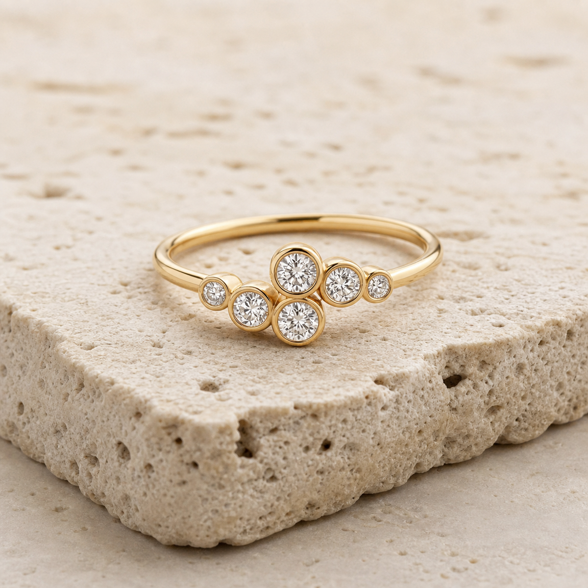 Elara Bezel Cluster Ring in gold on stone background