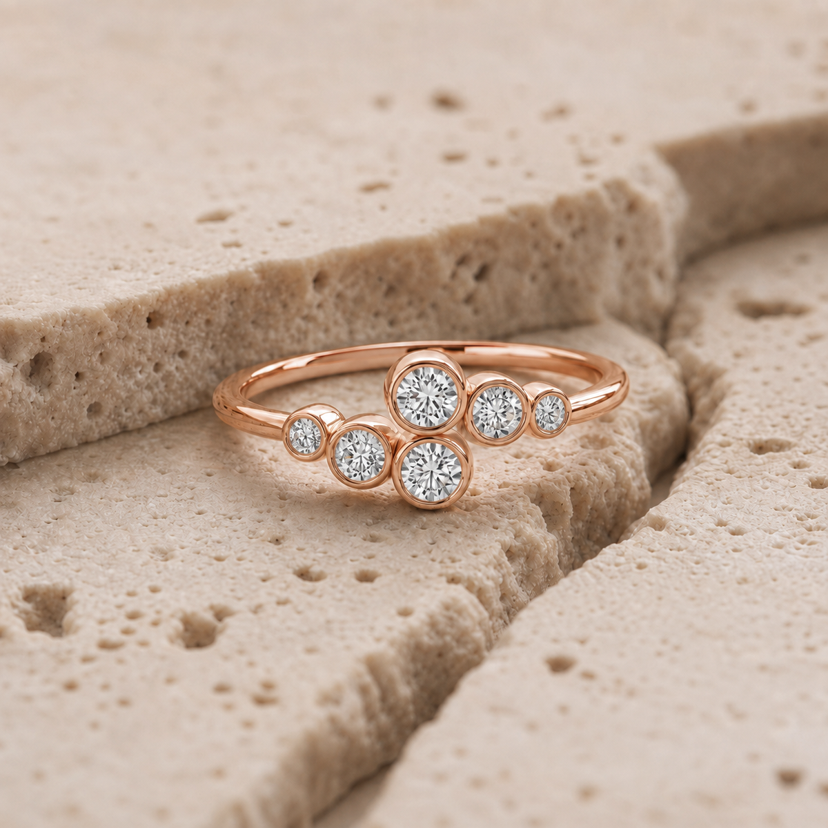Elara Bezel Cluster Ring in rose gold on stone background