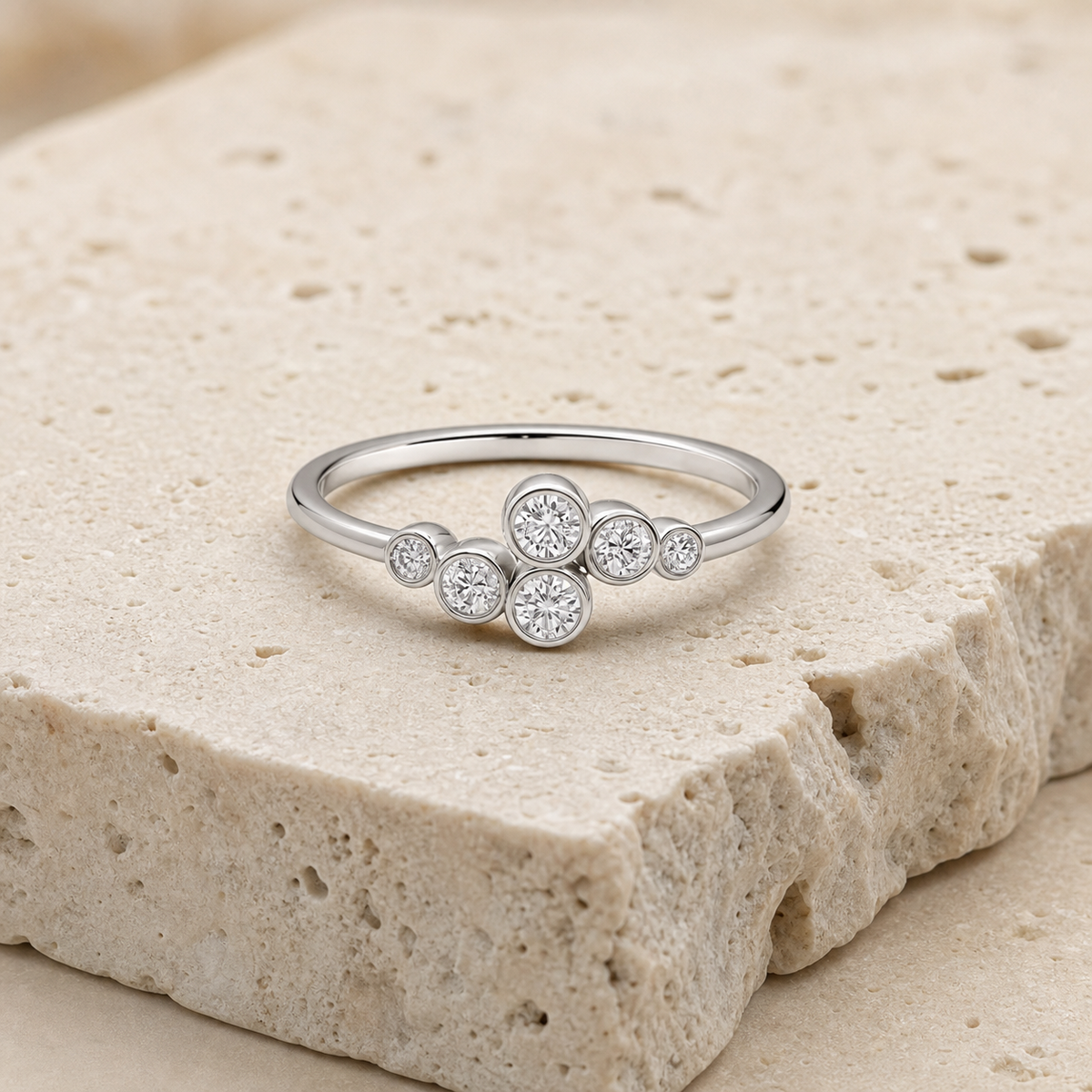 Elara Bezel Cluster Ring in silver on stone background