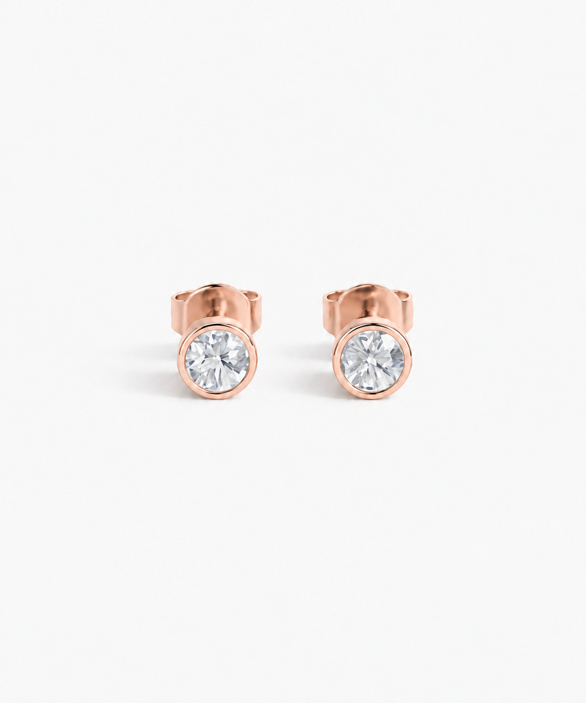 Hana Bezel Stud Earrings in rose gold on white background