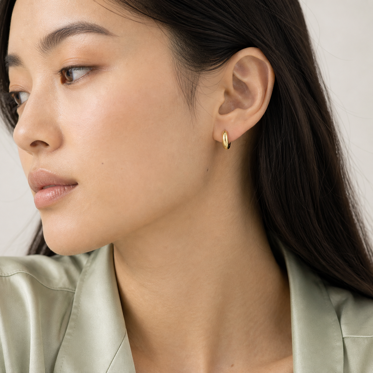 Vela Domed Huggie Earrings model 02 by SURI
