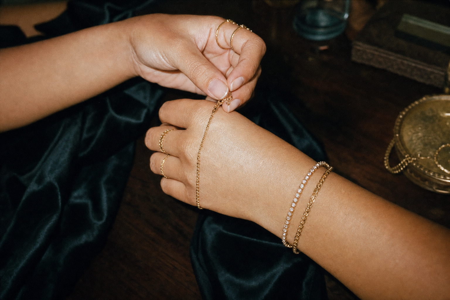 Gold bracelet and stacking ring details photographed on film