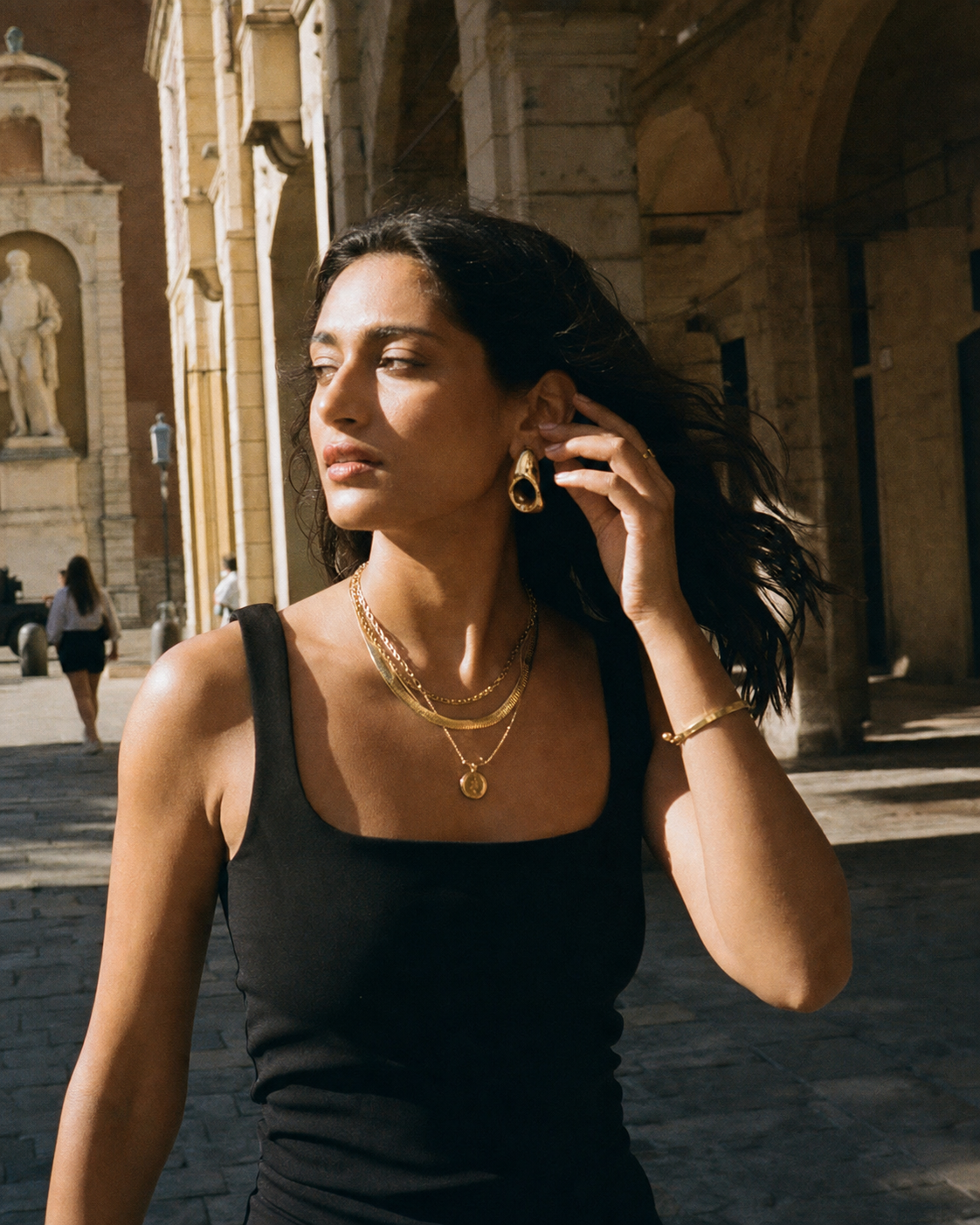 Suri jewelry in a sunlit stone arcade photographed on film